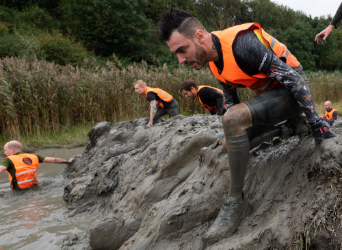een ultra viking deelnemer die onder de modder zit